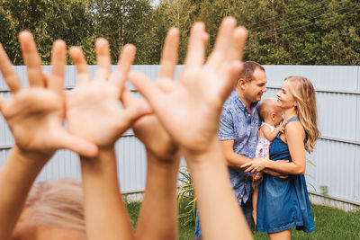 Rear view of friends standing outdoors