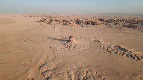 Scenic view of sand dune in desert against sky