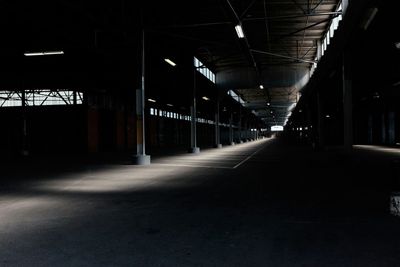 Empty road leading towards illuminated tunnel