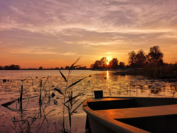 Scenic view of lake against orange sky