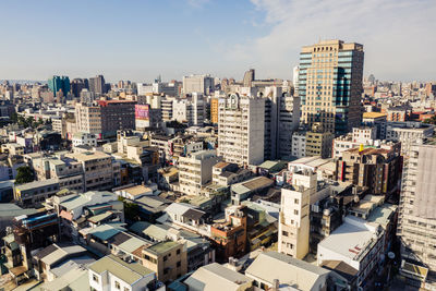 High angle view of buildings in city against sky