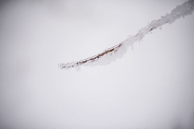 Low angle view of frozen ice against sky