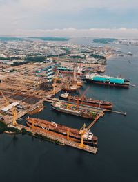 High angle view of cityscape by sea against sky