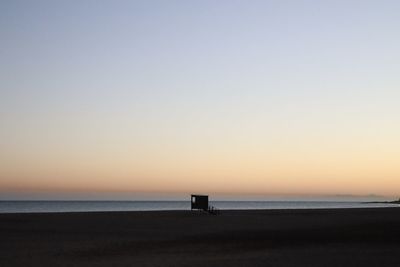 Scenic view of sea against clear sky during sunset