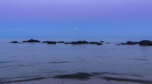 Scenic view of sea against clear blue sky