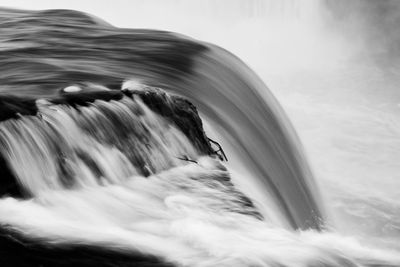 Scenic view of waterfall against sky