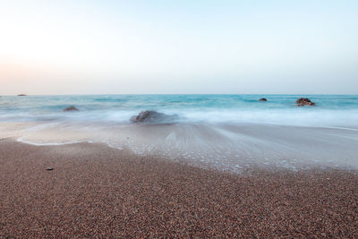 Scenic view of beach against clear sky