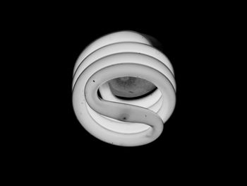 Close-up of electric lamp over black background