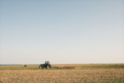 Scenic view of agricultural field against clear sky