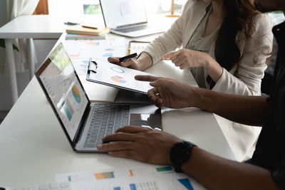 Midsection of business colleagues working at office
