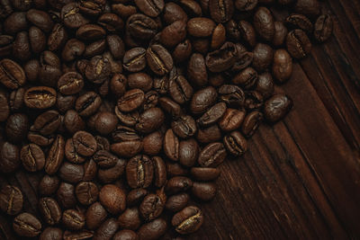Full frame shot of roasted coffee beans on table