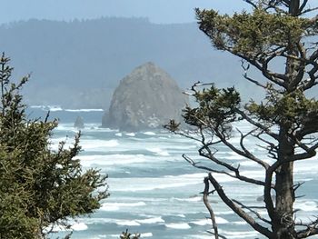 Scenic view of sea and mountains against sky