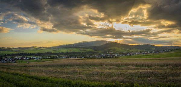 Scenic view of field against sky during sunset