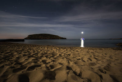 Scenic view of beach against sky at night