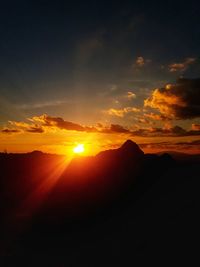 Scenic view of silhouette mountain against sky during sunset