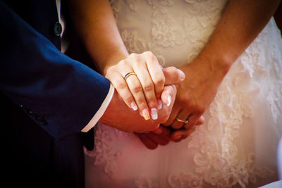 Midsection of couple holding hands