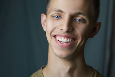 Close-up portrait of smiling young man