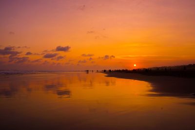 Scenic view of sea against orange sky