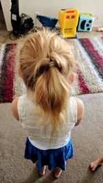 Rear view of girl with toy at home