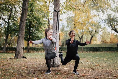 Low angle view of women exercising at park