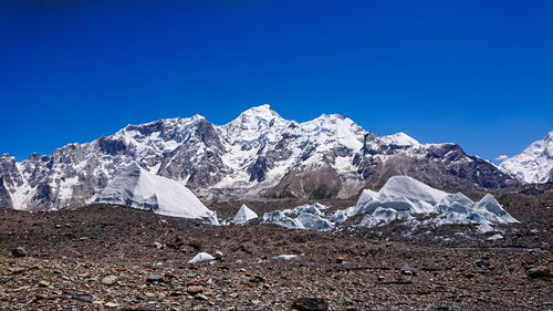 Scenic view of snowcapped mountains against clear blue sky