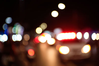 Defocused image of illuminated street lights at night