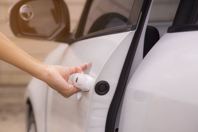Cropped image of person holding car