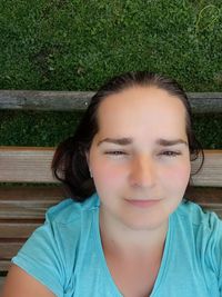 Portrait of smiling boy sitting on bench