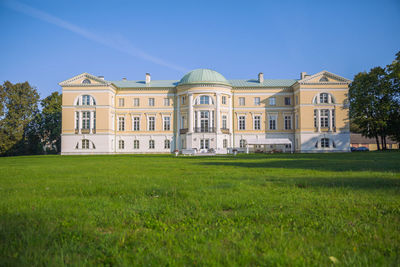 Lawn by building against sky