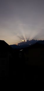 Silhouette buildings against sky during sunset