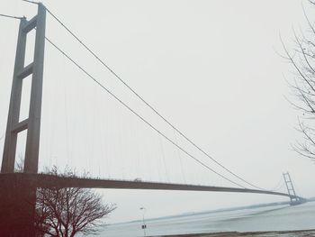 Low angle view of bridge over sea against clear sky