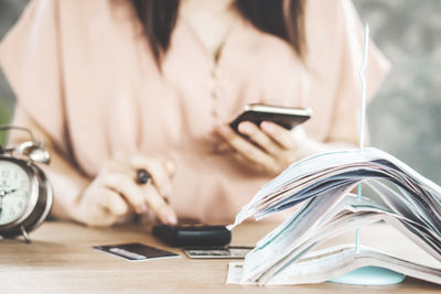 Midsection of woman using smart phone