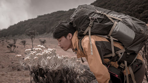 Side view of young man standing on land