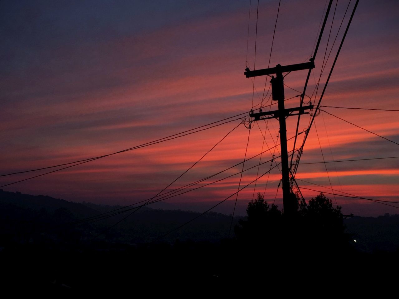 sunset, power line, electricity pylon, power supply, electricity, silhouette, cable, sky, connection, fuel and power generation, orange color, technology, tranquility, scenics, beauty in nature, power cable, cloud - sky, low angle view, tranquil scene, nature