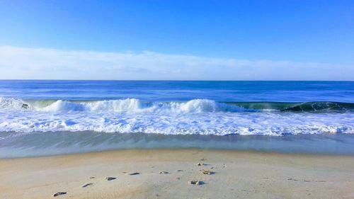 Scenic view of sea against blue sky