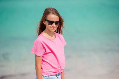 Woman wearing sunglasses while standing on beach