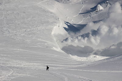 Person skiing on snowcapped mountain