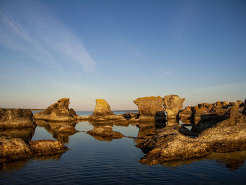 Panoramic view of rock, rauk formations against blue sky