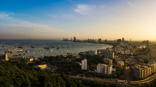 High angle view of city buildings against sky during sunset