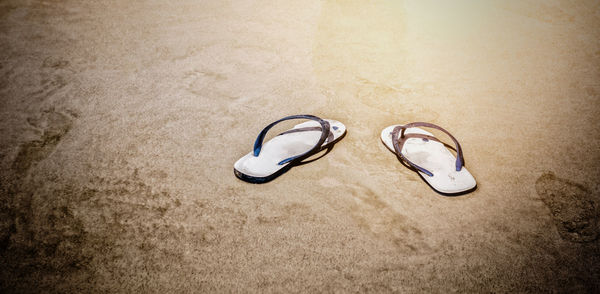 High angle view of shoes on sand