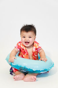 Portrait of cute boy against white background