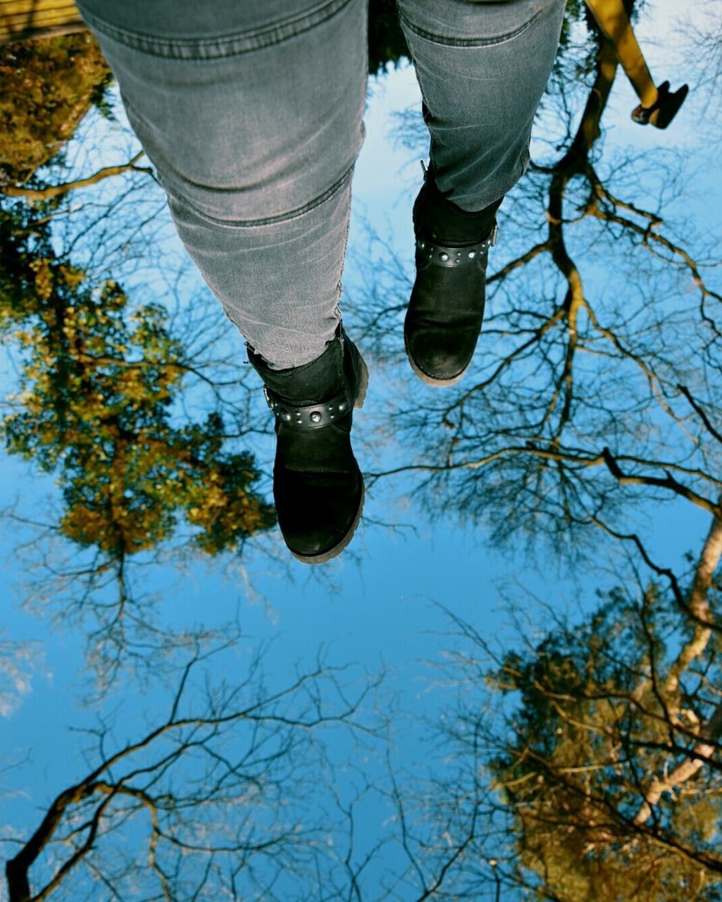 low section, shoe, human leg, body part, one person, human body part, day, nature, tree, real people, reflection, outdoors, water, lifestyles, plant, standing, leisure activity, human foot, jeans, human limb