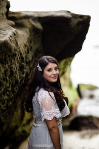 Portrait of a beautiful young woman standing outdoors