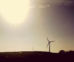 Sun shining through wind turbine