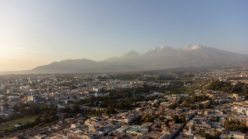 Aerial view of townscape against sky during sunset