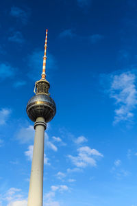 Low angle view of fernsehturm against blue sky