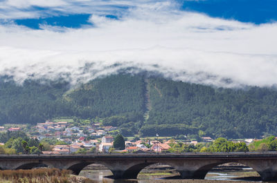 A sea of white clouds going down the mountains to the village of noia in galicia