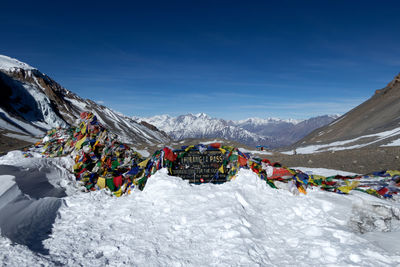 Panoramic shot of snowcapped mountains against blue sky