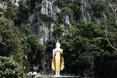 Low angle view of statue against trees