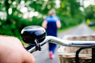 Close-up cropped hand holding bicycle